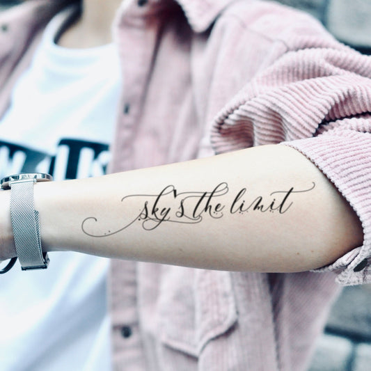 fake medium sky's the limit lettering temporary tattoo sticker design idea on forearm