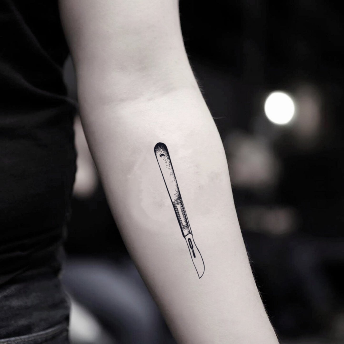 fake small scalpel illustrative temporary tattoo sticker design idea on inner arm