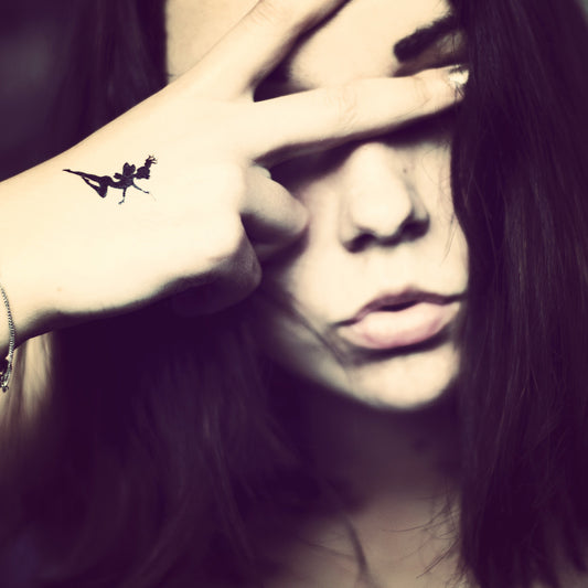 fake small tinkerbell cartoon temporary tattoo sticker design idea on wrist