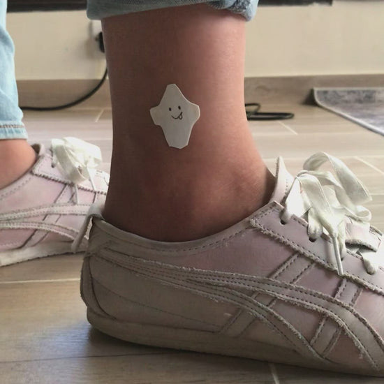 fake small halloween ghost minimalist temporary tattoo sticker design idea on leg ankle